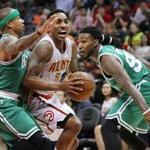 Atlanta Hawks' Jeff Teague drives through a double-team by Boston Celtics' Isaiah Thomas and Jae Crowder during the first half in Game 5 of a first-round NBA playoff basketball series Tuesday, April 26, 2016, in Atlanta. The Hawks won 110-83 and lead the series 3-2. (Curtis Compton/Atlanta Journal Constitution via AP)