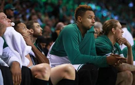04/28/16: Boston, MA: The Celtics Jared Sullinger munches on his jersey as he and his teammates on the bench watch the time run out in their season. The Boston Celtics hosted the Atlanta Hawks in Game Six of an NBA Eastern Conference Quarter Final Playoff basketball game at the TD Garden. (Globe Staff Photo/Jim Davis) section:sports topic:Celtics-Hawks
