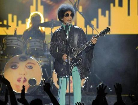 FILE - In this May 19, 2013, file photo, Prince performs at the Billboard Music Awards at the MGM Grand Garden Arena in Las Vegas. Tickets for what turned out to be Prince's last concert, in Atlanta, went on sale just eight days before he was scheduled to play and sold out almost instantly. (Photo by Chris Pizzello/Invision/AP, File)
