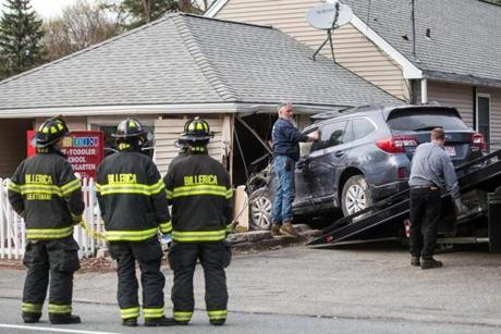 Firefighters and tow truck operators worked the scene after an SUV crashed into A Brighter Rainbow day care on Boston Road in Billerica.
