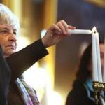 Holocaust survivor Eva Fleischmann Paddock lit the first of seven memorial candles at Faneuil Hall.