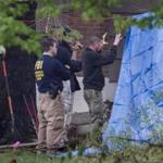 FBI officials paused for a discussion as they searched the home of gangster Robert Gentile in Manchester, Conn., Monday. 