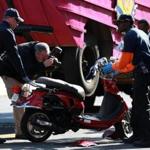 043032016 Boston Ma . A women was killed in a accident with a Duck Boat on Beacon and Charles Street in Boston. Investigators look at scene. Photographes are taken of bike at scene. Boston Globe/Staff Photographer Jonathan Wiggs
