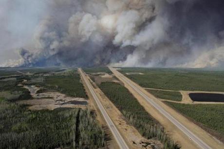 This image released by the Canadian National Defence on Thursday shows an aerial view of highway 63 as smoke from fires billowed south of Fort McMurray, taken from a CH-146 Griffon helicopter.
