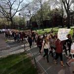 Protesters walked past the statue of John Harvard in Harvard Yard.