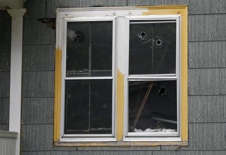 Bullet holes riddled a window of the Oxford house where Jorge Zambrano was killed.
