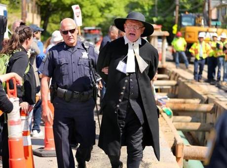 West Roxbury -5/25/16- Over a dozen clergy were arrested , including Rev. John Gibbons from The First Parish in Bedford, .at the West Roxbury Lateral Pipeline construction site on Grove Street as they sat on the edge of the 16 inch gas pipeline being laid five feet below the street, and halted the work from being done. Boston Globe staff Photo by John Tlumacki (metro)
