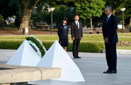 US President Barack Obama (R) holds a minute silence after placing a wreath at the cenotaph in the Peace Momorial park in Hiroshima on May 27, 2016 with Japanese Prime Minister Shinzo Abe. Obama on May 27 paid a moving tribute to victims of the world's first nuclear attack. / AFP PHOTO / TOSHIFUMI KITAMURATOSHIFUMI KITAMURA/AFP/Getty Images
