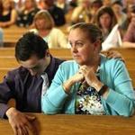 Scituate, MA - 05/29/16 - Christine Arnold(R) and Scott Arnold pray during the final service at St Francis X. Cabrini church in Scituate, MA, May 29, 2016. After 4,233 consecutive days in vigil, the parishioners of St. Frances X. Cabrini closed their spiritual home.(Keith Bedford/GlobeStaff)