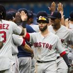 Boston Red Sox second baseman Dustin Pedroia, center, celebrates with teammates after defeating the Toronto Blue Jays during 11th inning baseball action in Toronto on Sunday, May 29, 2016. The Red Sox won, 5-3. (Nathan Denette/The Canadian Press via AP) MANDATORY CREDIT