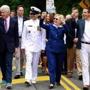 Democratic U.S. presidential candidate Hillary Clinton (2nd R) gestures to the crowd as she takes part in the Memorial Day parade with former U.S. President Bill Clinton (L) and New York State Governor Andrew Cuomo (R) in Chappaqua, New York, U.S. May 30, 2016. REUTERS/Adrees Latif