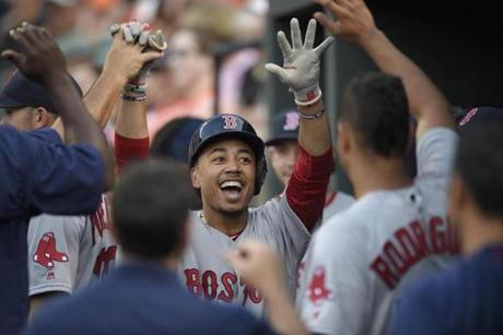 Boston Red Sox' Mookie Betts celebrates his home run in the dugout during the first inning of a baseball game against the Baltimore Orioles, Tuesday, May 31, 2016, in Baltimore. (AP Photo/Nick Wass)
