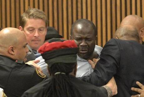 Court officers escort Van Terry, center, from the courtroom after he dove across a courtroom table to attack convicted serial killer Michael Madison shortly after a judge announced the defendant would be sentenced to death in Cuyahoga County Common Pleas Court Thursday, June 2, 2016, in Cleveland. Terry is the father of victim Shirellda Terry. (AP Photo/David Richard)
