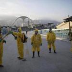 FILE - This is a Tuesday, Jan. 26, 2016 file photo of health workers as they get ready to spray insecticide to combat the Aedes aegypti mosquitoes that transmits the Zika virus under the bleachers of the Sambadrome in Rio de Janeiro, which will be used for the Archery competition in the 2016 summer games. With the opening ceremony just over two months away, Olympic leaders have plenty of challenges to discuss this week when they meet for the last time before gathering in Rio de Janeiro on the eve of South America?s first games. (AP Photo/Leo Correa, File)