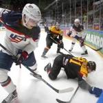 FILE - In this May 15, 2016 file photo, United States' Auston Matthews, left, fights for the puck with Germanys Torsten Ankert during a Hockey World Championships Group B match in St.Petersburg, Russia. Matthews spent the past year playing in Switzerland, where he established himself as the NHL's top-ranked draft prospect. Matthews is from Arizona and among more than 100 draft-eligible players taking part in the league's rookie combine in Buffalo. (AP Photo/Dmitri Lovetsky, File)