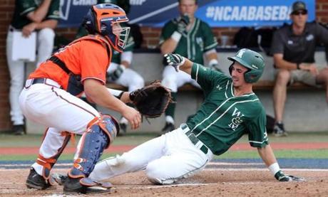 William & Mary infielder Kyle Wrighte (8) scores a run past Virginia catcher Matt Thaiss (21) during an NCAA regional baseball game in Charlottesville, Va., Sunday, June 5, 2016. William & Mary ended Virginia's season with a 5-4 victory. (Andrew Shurtleff/The Daily Progress via AP)
