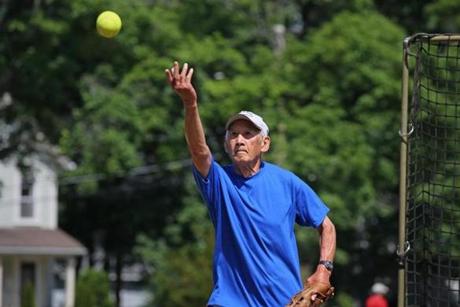 Jimmy Wong, 87,  pitches during a slow pitch softball game in Wayland.
