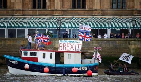 Campaigners to remain in the EU unfurled a banner on Westminster Bridge as a bus bearing the face of UKIP leader Nigel Farage and a message urging voters to leave in the referendum sat behind it. 

