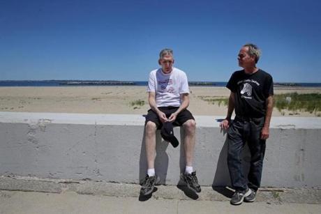 Jon Rodis, left, needed to stop during a walk with his lifelong friend Lloyd Caplan on the shore in Winthrop. 
