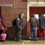 Homeless people wait to be admitted to the Boston Night Center last January.