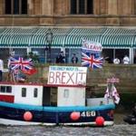 Campaigners to remain in the EU unfurled a banner on Westminster Bridge as a bus bearing the face of UKIP leader Nigel Farage and a message urging voters to leave in the referendum sat behind it. 