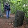 Mike Ryan, former executive director of the Friends of the Middlesex Fells Reservation, examined a mysterious stone marker on the island in Stoneham pond. 