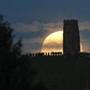 GLASTONBURY, ENGLAND - JUNE 20: A full moon rises behind Glastonbury Tor as people gather to celebrate the summer solstice on June 20, 2016 in Somerset, England. Tonight's strawberry moon, a name given to the full moon in June by Native Americans because it marks the beginning of strawberry picking season, last occurred on the solstice on June 22, 1967 and it will not happen again on the summer solstice for another 46 years until June 21, 2062. (Getty Images)