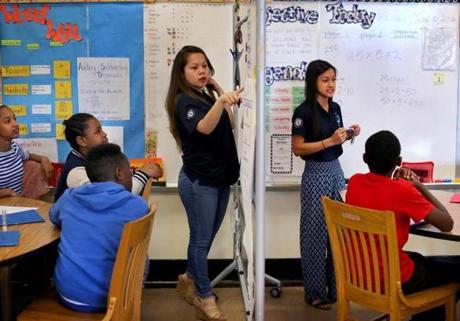 Dorchester- 6/10/2016 Math tutors work in small groups at the Dever Elementary School. Instructors Loan Nguyen(cq) (left) and Nguyen Le(cq) (right) work with their own small groups separated by a white board during a 5th grade math class. Boston Globe staff photo by John Tlumacki(metro)
