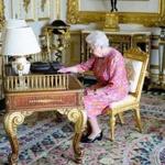 Britain?s Queen Elizabeth II tweeted using a tablet in the Drawing Room in Windsor Castle. 