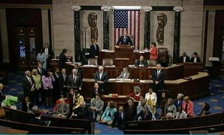 In this frame grab taken from AP video Georgia Rep. John Lewis, center, leads a sit-in of more than 200 Democrats in demanding a vote on measures to expand background checks and block gun purchases by some suspected terrorists in the aftermath of last week's massacre in Orlando, Florida, that killed 49 people in a gay nightclub. Rebellious Democrats shut down the House's legislative work on Wednesday, June 22, 2016, staging a sit-in on the House floor and refusing to leave until they secured a vote on gun control measures before lawmakers' weeklong break. (AP Photo)
