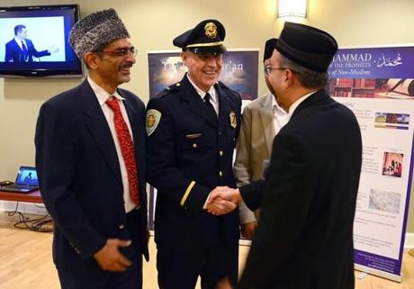 The Ahmadiyya Muslim Community of Boston hosted an Iftar dinner with a reception, guest speakers, and an introduction to Islam at the Sharon Community Center. From left to right, Dr. Amer Malik, Sharon police Lieutenant Donald Brewer, and Nasir Rana greet one another.
