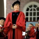 Civil right advocate Mary Bonauto, center, receives applause from former President of Brazil Fernando Henrique Cardoso, left, and filmmaker Steven Spielberg, right, as she is introduced before being presented with an honorary doctor of laws degree during Harvard University commencement exercises, Thursday, May 26, 2016, in Cambridge, Mass. (AP Photo/Steven Senne)