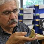 Robert Megerdichian looks over a miniature Hoover vacuum cleaner crafted by his father. 
