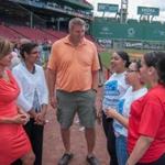 From left: WCVB?s Maria Stephanos; ABCD?s Sharon Scott-Chandler; former Patriots player Max Lane, and youth from the ABCD SummerWorks program at Fenway Park.
