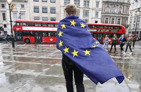 A demonstrator wrapped in a European flag leaves an anti-Brexit protest in Trafalgar Square in central London on June 28, 2016. EU leaders attempted to rescue the European project and Prime Minister David Cameron sought to calm fears over Britain's vote to leave the bloc as ratings agencies downgraded the country. Britain has been pitched into uncertainty by the June 23 referendum result, with Cameron announcing his resignation, the economy facing a string of shocks and Scotland making a fresh threat to break away. / AFP PHOTO / JUSTIN TALLISJUSTIN TALLIS/AFP/Getty Images
