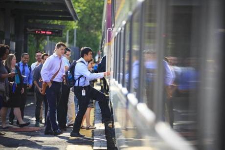 Commuters boarded a Commuter Rail train at the Chelsea platform. 
