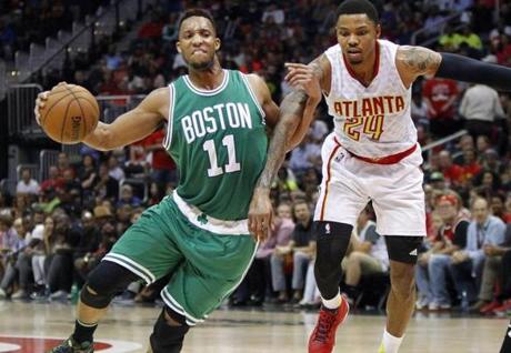 Apr 26, 2016; Atlanta, GA, USA; Boston Celtics guard Evan Turner (11) is defended by Atlanta Hawks forward Kent Bazemore (24) in the third quarter in game five of the first round of the NBA Playoffs at Philips Arena. The Hawks defeated the Celtics 110-83. Mandatory Credit: Brett Davis-USA TODAY Sports
