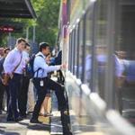 Commuters boarded a Commuter Rail train at the Chelsea platform. 