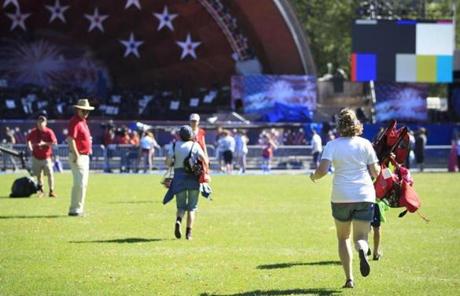 Revelers raced to secure spots in front of the Hatch Shell after cleaning security Monday morning just after 9 a.m. The Boston Pops concert starts later in the evening. 
