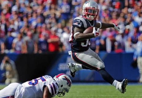 Orchard Park, NY - 09/20/15 - (2nd quarter) New England Patriots running back Dion Lewis (33) hurdles a Buffalo Bills defender for a 12 yard gain for a first down in the second quarter. The New England Patriots take on the Buffalo Bills at Ralph Wilson Stadium in Orchard Park, NY. - (Barry Chin/Globe Staff), Section: Sports, Reporter: Michael Whitmer, Topic: 21Patriots-Bills, LOID: 8.1.3611291606. 
