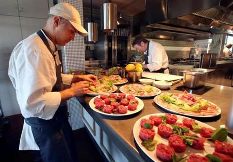A staff member prepares cured meat dishes at the Eataly motorway restaurant on a highway in Modena, central Italy, May 30, 2016. REUTERS/Stefano Rellandini
