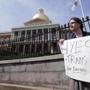 Asa Goodwillie of Watertown, Mass., who is transgender, protested outside the State House in Boston in June.