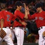 Boston, MA - 7/08/2016 - (9th inning) Boston Red Sox shortstop Xander Bogaerts (2), Boston Red Sox relief pitcher Koji Uehara (19), and Boston Red Sox third baseman Aaron Hill (18) celebrate the 6-5 win over the Tampa Bay Rays. The Boston Red Sox take on the Tampa Bay Rays in Game 1of a 3 game series at Fenway Park. - (Barry Chin/Globe Staff), Section: Sports, Reporter: Peter Abraham, Topic: 09Red Sox-Rays, LOID: 8.2.3564536203.