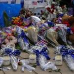 Candle tributes to the five slain officers were left in front of Dallas police headquarters.