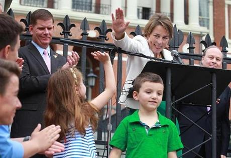 Attorney General Maura Healey gave a high five to Ella Lemay, whose brother, Jacob is transgender. 
