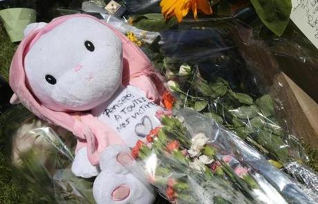 FRANCE SLIDER2 A child's toy is placed among the floral tributes laid out near the site of the truck attack in the French resort city of Nice, southern France, Friday, July 15, 2016. France has been stunned again after a large white truck killed many people after it mowed through a crowd of revellers gathered for a Bastille Day fireworks display in the Riviera city of Nice. (AP Photo/Luca Bruno)
