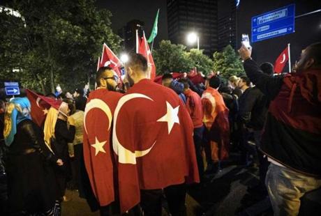 Protesters gather for a demonstration against a military coup in Turkey in front of the Turkish consulate in Rotterdam on July 16, 2016. Scores of members from Turkish armed forces were arrested across the country after a coup attempt blamed by the government on supporters of US-based cleric Fethullah Gulen, the state-run Anatolia news agency reported. 754 members of Turkish armed forces were arrested for involvement in the coup, the agency said. A Turkish official added that 29 colonels and 5 generals had been removed from their posts. At least 60 people were killed in the turmoil. / AFP PHOTO / ANP / Marten van Dijl / Netherlands OUT
