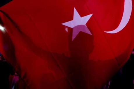 A man waves a Turkish flag during a march around Kizilay Square in Ankara, Turkey.
