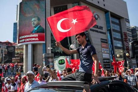 A man waved a Turkish flag from the roof of a car during a march around KizilaySquare in reaction to the attempted military coup.
