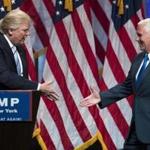 Republican presidential candidate Donald Trump (left) shook hands Saturday with Governor Mike Pence of Indiana, his running mate.
